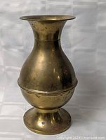 Full view of brass vase showing overall form and foot