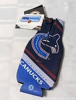 Front view of navy neoprene koozie with Vancouver Canucks logo