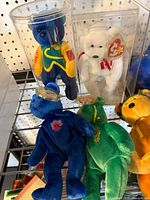 Top shelf bears in display cases and loose bears below