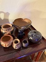 Group view of all seven pottery pieces on tabletop