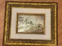 Entire framed painting showing gilt frame and inner artwork