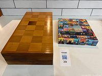Closed wood chess box next to puzzle box