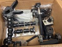Box containing HERO3 camera, dolly, Jaws clamp, flex neck arms, selfie stick, housing and packaged hardware