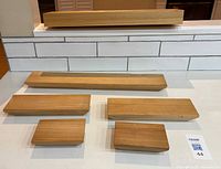 front view of all six wooden shelves set on counter