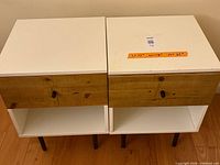 Both bedside tables side-by-side showing tops, drawer fronts, open shelves, and legs