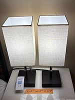 Front view of both illuminated lamps showing shades and bases with outlets