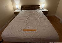 Bed frame assembled with mattress placed on top