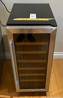 Front view showing stainless steel glass door, handle and interior shelves