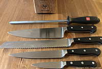 Knives and honing steel laid out next to block