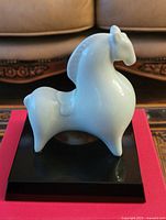 Overall view of porcelain horse figurine on black base