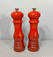 Front view of both flame red Le Creuset mills