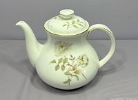 Right side view of Royal Doulton Yorkshire Rose teapot showing spout, handle, lid, floral motif and gold trim