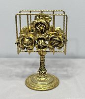 Front view of brass rose pedestal napkin holder