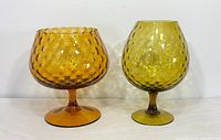 Front view showing both Empoli glass vases, amber left, olive right