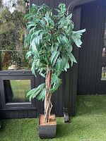 Full view of artificial plant in planter