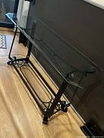 Full view of console table showing glass top and metal base