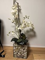 Full view of artificial lily arrangement in glass vase
