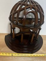 Front view of wooden dome staircase model on base with tape for scale