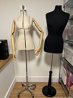Front view of both dress forms showing canvas form with wood arms and black form