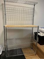 Full view of baker's rack showing shelves and wood top