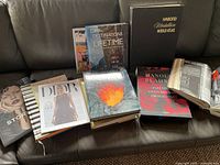 All eight large books spread on sofa