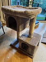 Front view showing two cubbies, top perch and posts