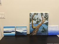 Front view of all four paintings on tabletop