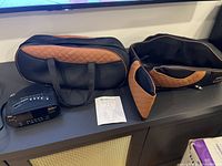 Sony clock radio, Triducna carry bag, massager and manual on shelf