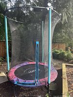 Full view of Plum Play 4.7-ft trampoline with enclosure net and zipper entry