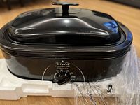 Front view of Rival roaster oven showing temperature dial and lid