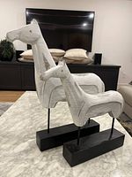 Front view of both horse statues on table