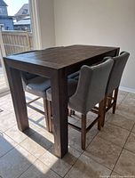 Table assembled with stools around to show scale