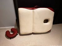 Massage table folded with face rest beside it