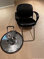 Seat separated from hydraulic base, showing mounting mechanism and chrome round pedestal