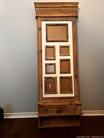 Full view of tall wooden frame with multiple photo openings