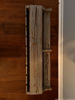 Front view of entire wooden wine rack showing distressed paint and overall structure