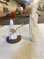 Both figurines side by side on table