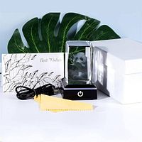 Glass panda ornament on LED base beside USB cable, cloth, greeting card, and gift box