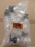 Bagged set of clear plastic bottles with black pump tops