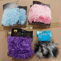 Front view of four trims: light blue, pink ombré, purple, black-gray feather