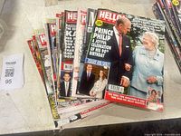 Stack of magazines showing multiple Hello! issues, Prince Philip 90th birthday cover visible