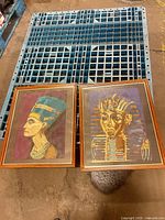 Both framed embroideries side by side