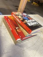 Stack of six books showing spines and covers