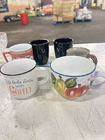Group shot showing all seven mugs arranged on table