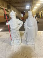 Both white ceramic figurines side by side showing overall appearance and height