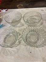 All four clear ribbed glass bowls displayed together