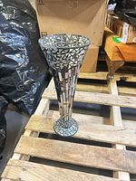 Full view of candle holder standing on pallet