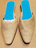 Top view of both mules showing woven uppers and blue scalloped insoles
