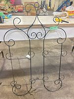 Full frontal view of wrought iron scrollwork wall rack