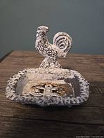 front view showing rooster figure and tray